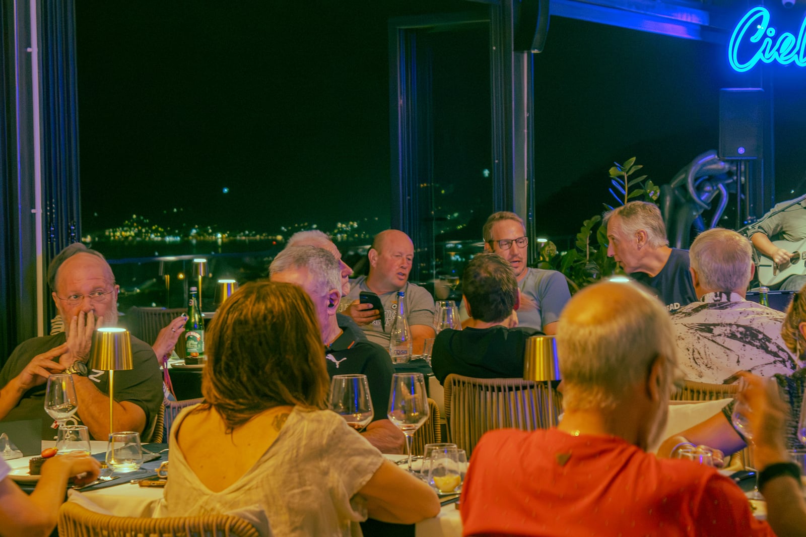 Guests dining with live music and bay views at Cielo