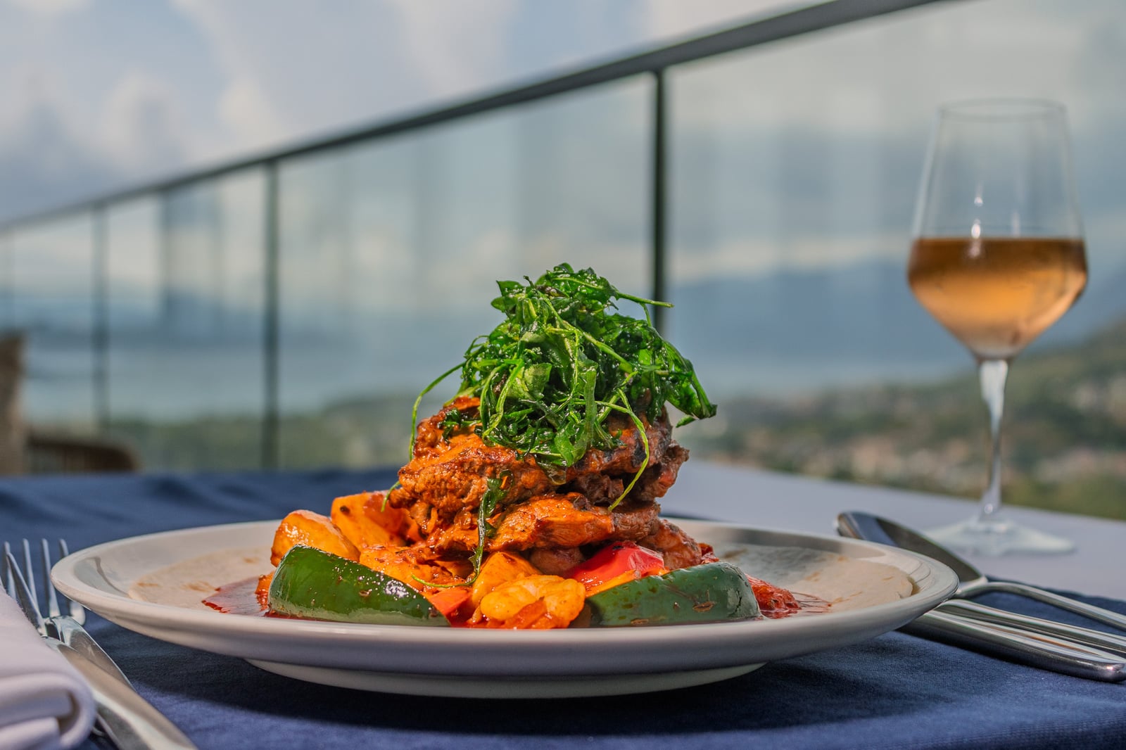 A plated main course with vegetables and greens at Cielo
