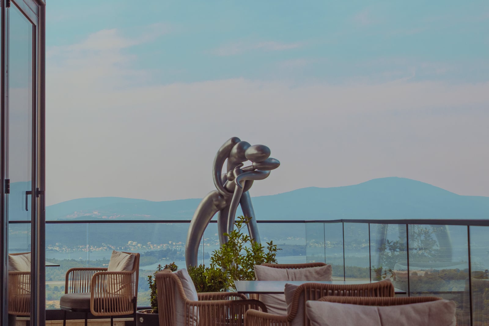 Rooftop seating and sculpture overlooking Kotor Bay at Cielo
